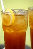 A glass of iced tea with ice and lemon