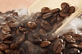 Steaming coffee beans with a scoop