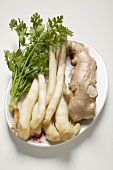 Ginger root, galangal and fresh coriander on platter
