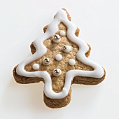 Christmas tree shaped biscuit with white icing and silver dragees