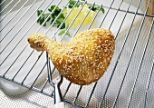 A chicken leg with a sesame seed crust