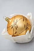 Gold Christmas bauble in paper