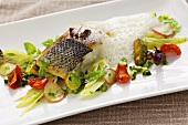 Fried branzino (sea bass) with spring vegetables and foam sauce