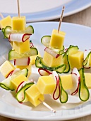 Cheese, cucumber and radishes on cocktail sticks