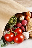 Vegetables and wholemeal bread in a paper bag