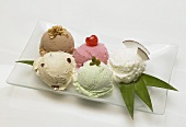 Five different flavours of ice cream on dessert plate