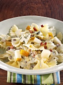 Farfalle with cheese and bacon sauce and pears