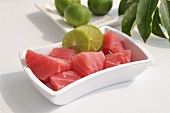 Raw tuna fillet with slices of lime