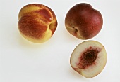 Two whole nectarines and half of a nectarine