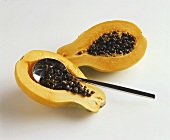 Removing papaya seeds with a spoon