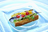 Baguette with anchovies and diced pepper