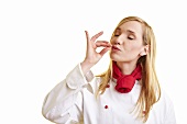 Blond female chef blowing a kiss