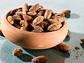 Salted almonds in terracotta bowl