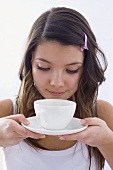 Girl smelling a scented cup of tea
