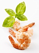 Four peeled prawns with basil