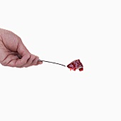 Hand holding a spoon with jam