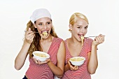 Two women eating spaghetti