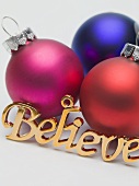 Coloured baubles and the word 'Believe' (tree ornaments)