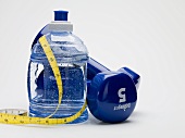 Bottle of water, hand weights and tape measure