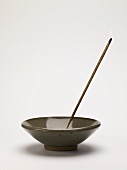 Incense stick in ceramic dish