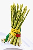 Green asparagus wrapped in tape measure