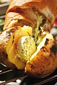Barbecued potato with herb butter and rosemary, baguette
