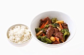 Fried beef with vegetables and a bowl of rice