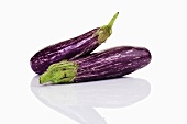 Two purple and white striped baby aubergines