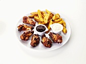Barbecue chicken wings with potato wedges and dips