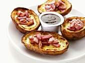 Baked potatoes with cheese, ham and dip
