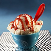 Single Scoop of Vanilla Ice Cream with Strawberry Sauce; In Bowl with Spoon