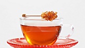 A cup of tea with a sugar swizzle stick
