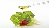 Pouring oil over romaine lettuce