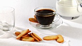 A cup of coffee with biscuits