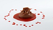 Mousse au chocolat with chocolate curls and berry sauce