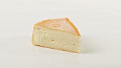 A piece of red washed rind cheese