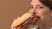 Junge Frau isst ein Sandwich