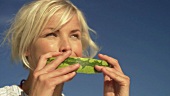 Young woman eating watermelon at picnic