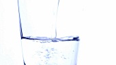 Pouring water into a glass (close-up)