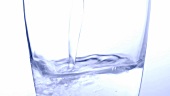 Pouring water into a glass (close-up)