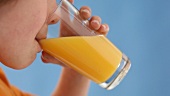 Boy drinking a glass of orange juice