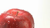 A rotating apple with drops of water