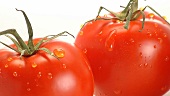 Two tomatoes with drops of water