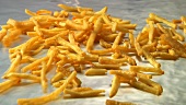 Spreading cooked chips out on a baking tray