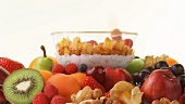 Fresh fruit and bowl of cornflakes, milk and berries