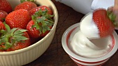 Dipping a strawberry in yoghurt