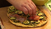 Pizza topped with grilled courgette slices and ham