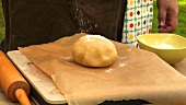 Dusting a ball of dough with flour