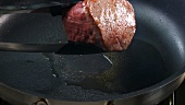 Frying beef fillet in a frying pan