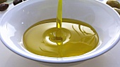 Pouring olive oil into a dish
